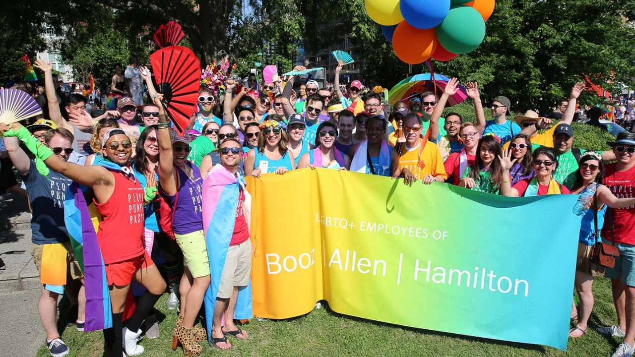 Group of Booz Allen employees supporting LGBTQ+ pride.
